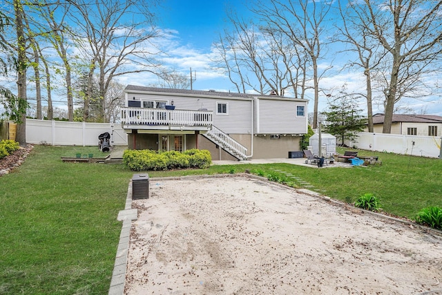 rear view of house featuring a patio, a fenced backyard, stairs, and a deck