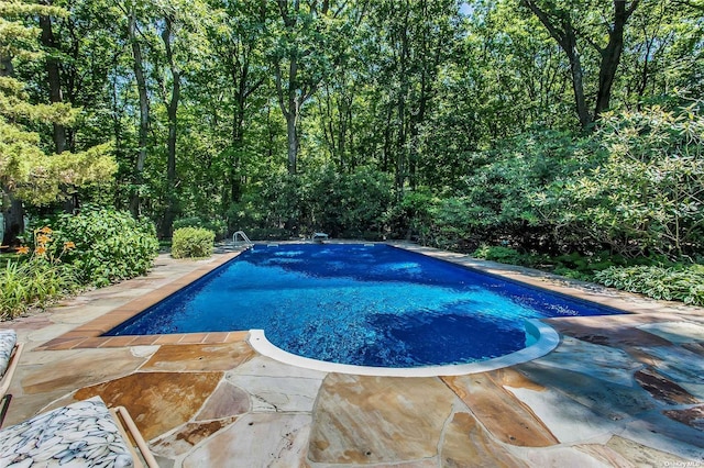 outdoor pool with a patio area