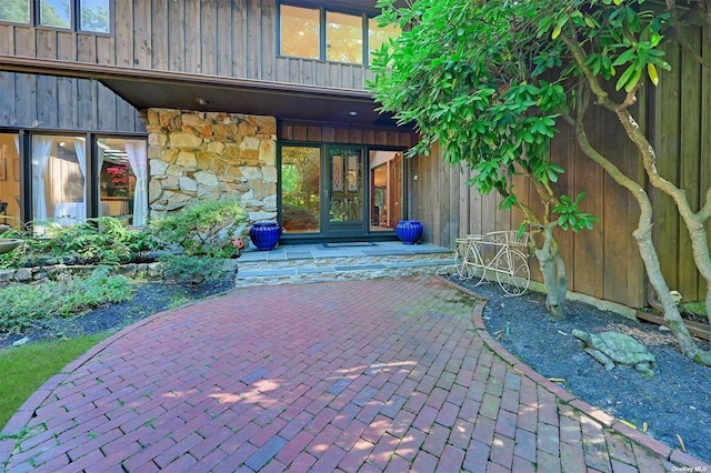 doorway to property featuring stone siding