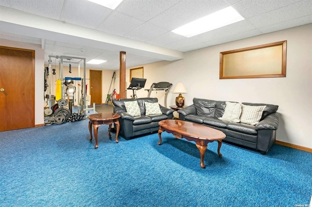 living room with baseboards, a paneled ceiling, and carpet