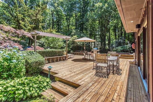 wooden terrace featuring a pergola and outdoor dining area