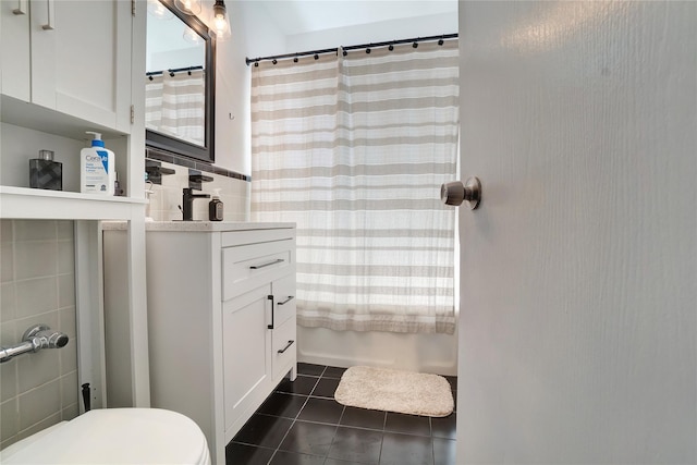 bathroom featuring curtained shower, tile walls, toilet, vanity, and tile patterned flooring