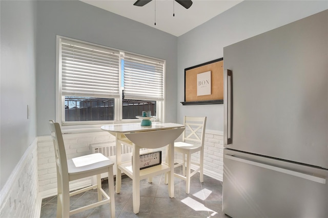 tiled dining area with ceiling fan