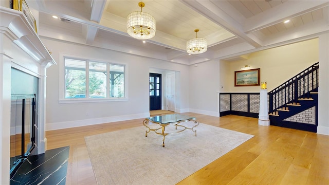 entryway with a chandelier, beam ceiling, and coffered ceiling