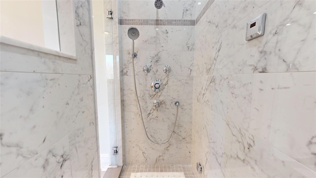 interior space featuring a marble finish shower