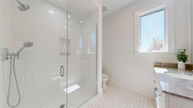 full bathroom with baseboards, toilet, vanity, tile patterned flooring, and a stall shower