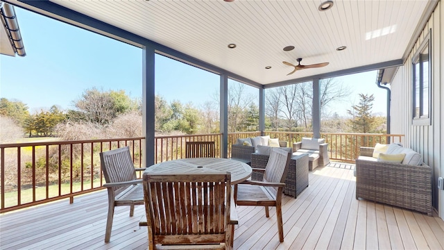 sunroom with an outdoor living space and a ceiling fan