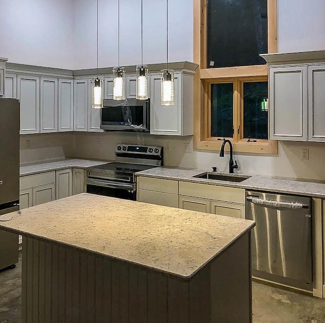 kitchen featuring concrete flooring, light stone countertops, a sink, appliances with stainless steel finishes, and decorative light fixtures