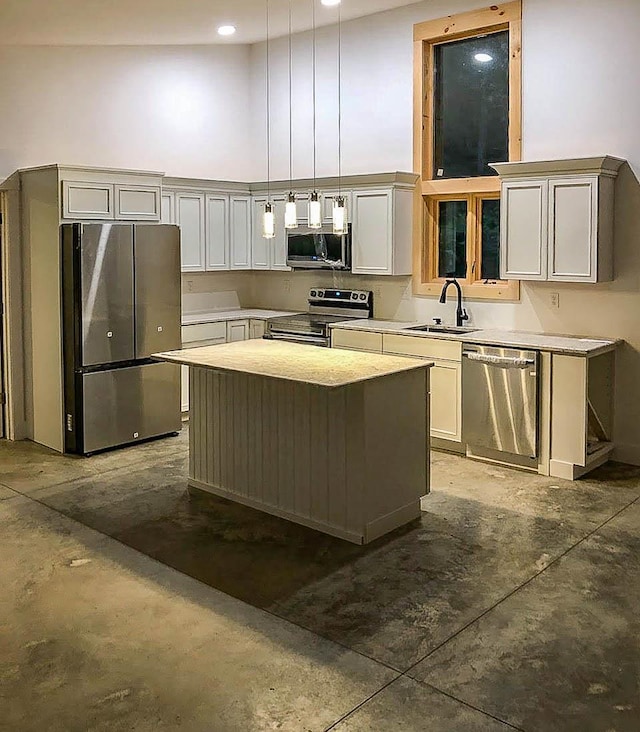 kitchen featuring stainless steel appliances, a high ceiling, concrete flooring, and a sink