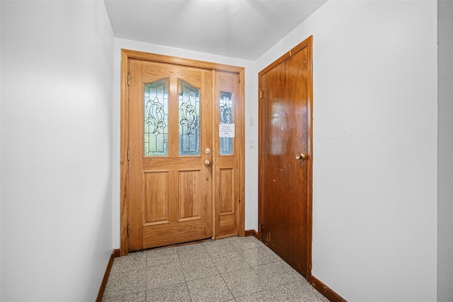entryway featuring baseboards and granite finish floor