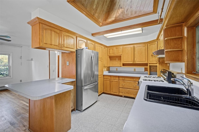kitchen featuring open shelves, freestanding refrigerator, a peninsula, under cabinet range hood, and white range with gas cooktop