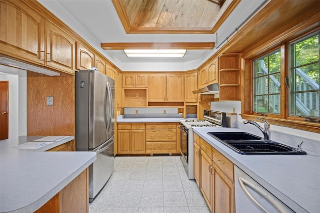 kitchen featuring freestanding refrigerator, open shelves, under cabinet range hood, gas stove, and a sink