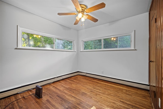 unfurnished room with ceiling fan, a baseboard heating unit, and a healthy amount of sunlight