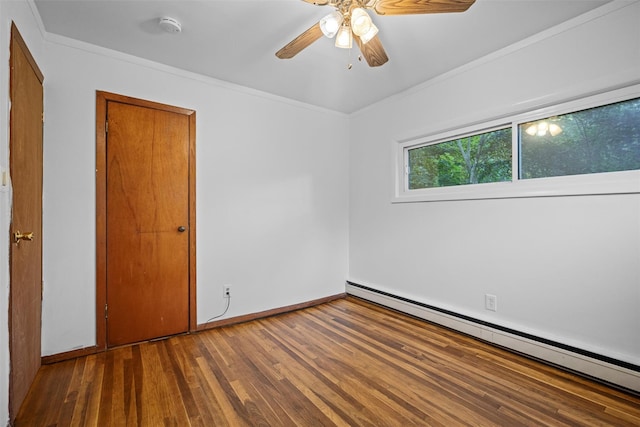 unfurnished room with baseboard heating, baseboards, ornamental molding, a ceiling fan, and wood finished floors