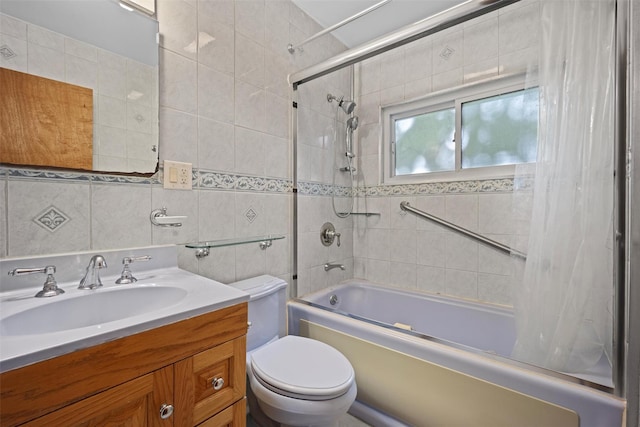 bathroom with shower / bath combination with curtain, toilet, vanity, and tile walls