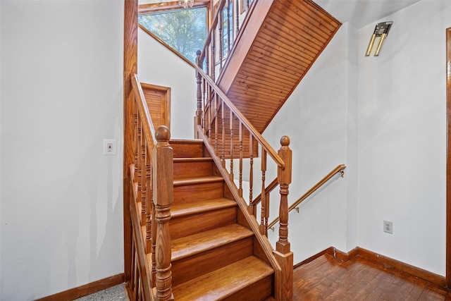 stairs with baseboards and wood finished floors