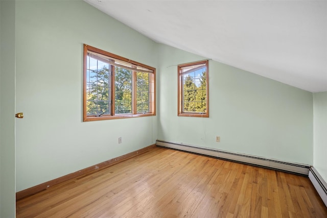 bonus room featuring vaulted ceiling, a baseboard heating unit, a baseboard radiator, light wood finished floors, and baseboards