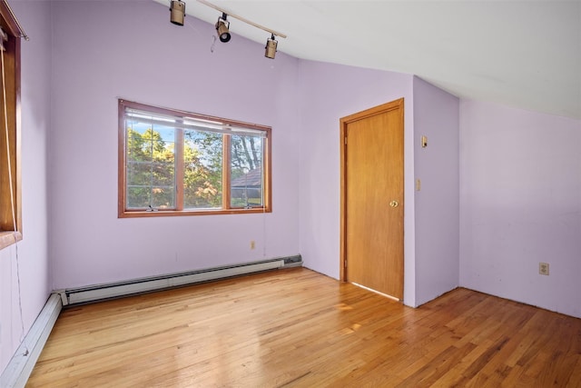 bonus room featuring baseboard heating, a baseboard radiator, vaulted ceiling, and light wood-style flooring