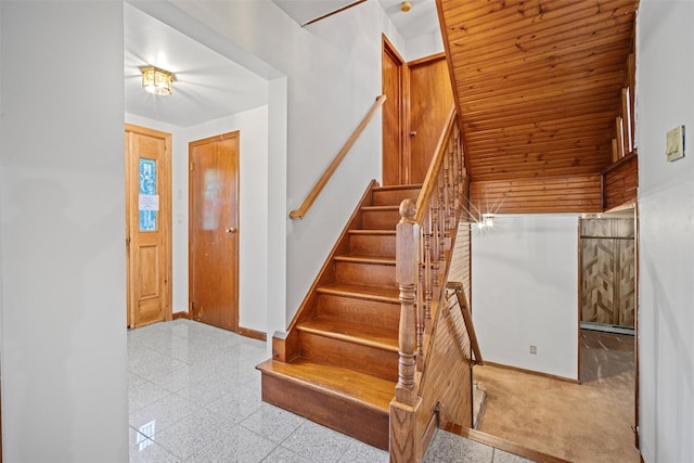 stairway featuring baseboards and granite finish floor