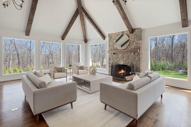 living room featuring wood finished floors, a fireplace, and lofted ceiling with beams