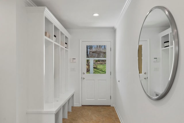 mudroom featuring crown molding, baseboards, and light tile patterned flooring