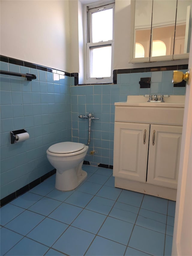 2866 Philip Ave, Bronx, NY 10465 - bathroom featuring tile walls, tile patterned floors, toilet, a wainscoted wall, and vanity