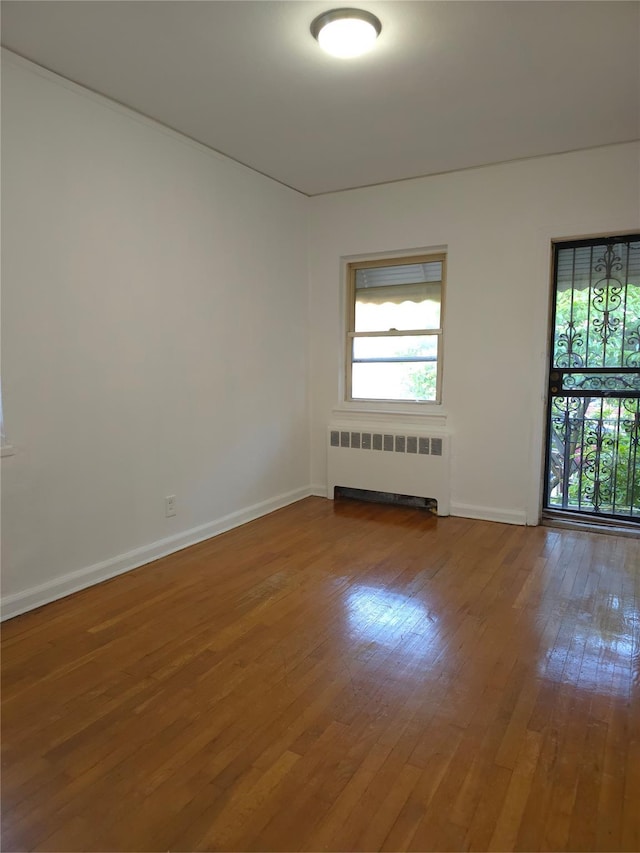 2866 Philip Ave, Bronx, NY 10465 - empty room with radiator, hardwood / wood-style flooring, plenty of natural light, and baseboards