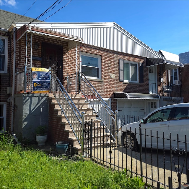 2864 Philip Ave, Bronx, NY 10465 - view of front facade with a garage, brick siding, a fenced front yard, and driveway