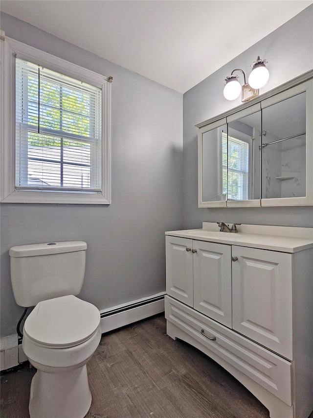 65 Biscayne Dr, Selden, NY 11784 - bathroom with baseboard heating, wood finished floors, and healthy amount of natural light
