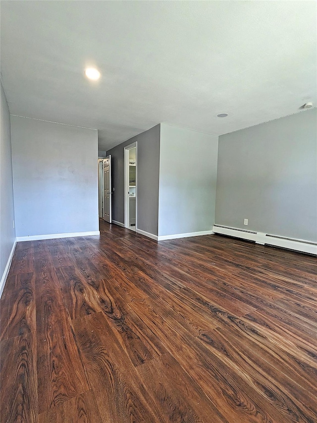 65 Biscayne Dr, Selden, NY 11784 - spare room featuring dark wood-style flooring, baseboards, and a baseboard heating unit