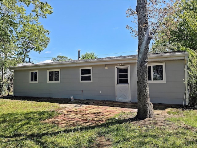65 Biscayne Dr, Selden, NY 11784 - rear view of house with a patio area and a lawn