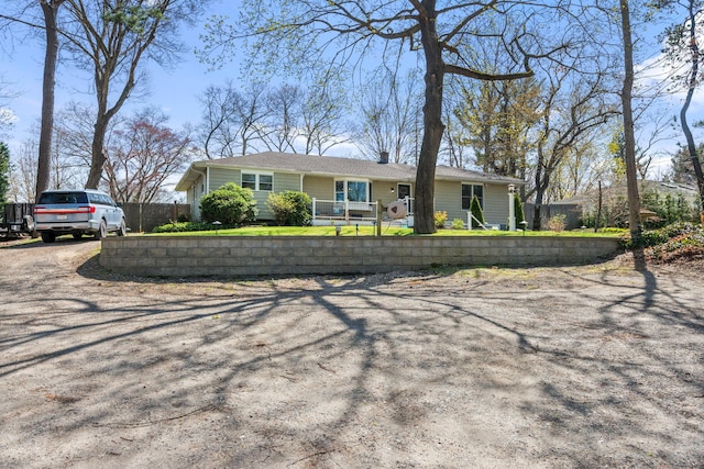 ranch-style house featuring fence