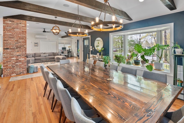 dining space featuring a wealth of natural light, an inviting chandelier, light wood-type flooring, and a wall unit AC