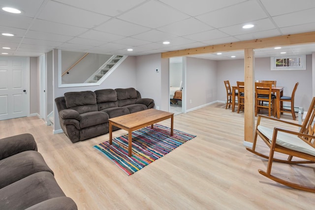 living room with recessed lighting, baseboards, stairs, and light wood-style flooring