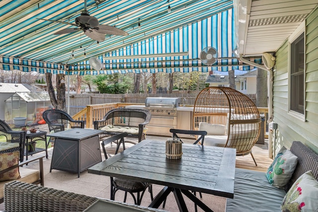 view of patio / terrace featuring outdoor dining area, area for grilling, fence, and an outdoor living space