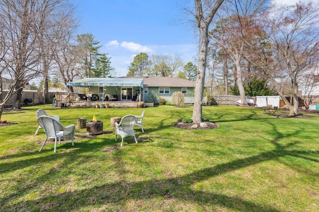 back of house featuring a fenced backyard, a deck, and a lawn