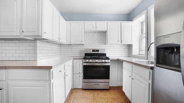 150-31 Hoover Ave, Briarwood, NY 11432 - kitchen with appliances with stainless steel finishes, white cabinets, decorative backsplash, and light countertops
