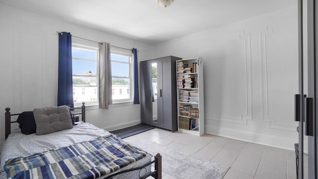 150-31 Hoover Ave, Briarwood, NY 11432 - bedroom featuring light tile patterned flooring and baseboards