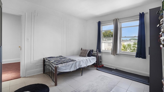150-31 Hoover Ave, Briarwood, NY 11432 - bedroom with light tile patterned flooring and radiator heating unit