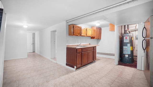 150-31 Hoover Ave, Briarwood, NY 11432 - kitchen featuring water heater, freestanding refrigerator, light countertops, and a baseboard radiator