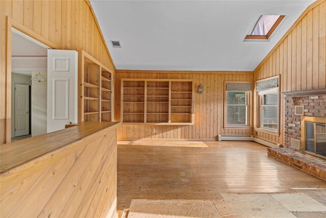 46 Mount Grey Rd, Setauket, NY 11733 - unfurnished sunroom with a skylight, baseboard heating, and vaulted ceiling