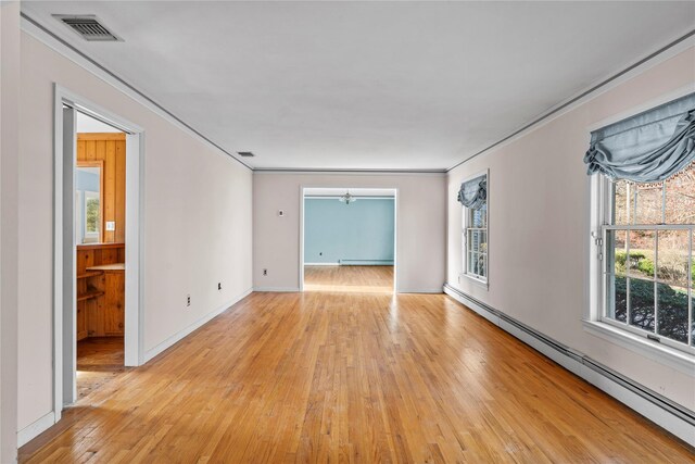46 Mount Grey Rd, Setauket, NY 11733 - spare room featuring a baseboard heating unit, light wood-style floors, crown molding, healthy amount of natural light, and baseboards