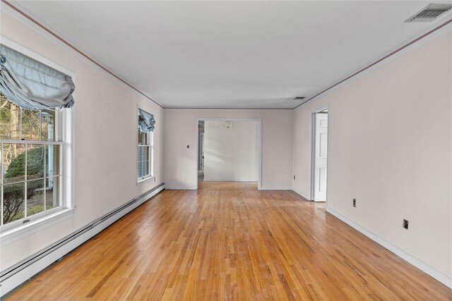46 Mount Grey Rd, Setauket, NY 11733 - empty room featuring baseboard heating, light wood-style floors, crown molding, and baseboards