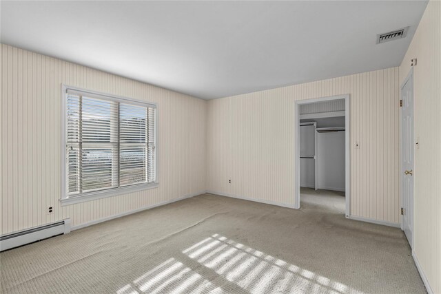 46 Mount Grey Rd, Setauket, NY 11733 - unfurnished bedroom with light carpet, a spacious closet, baseboard heating, and a closet