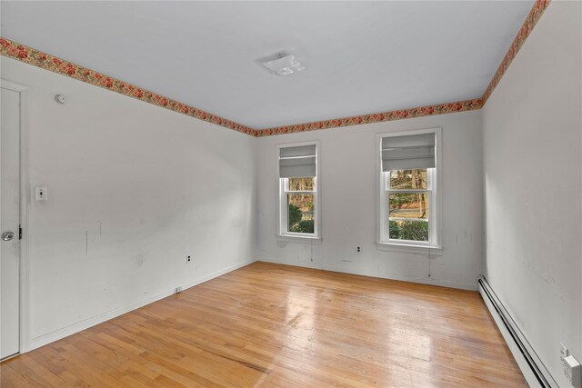 46 Mount Grey Rd, Setauket, NY 11733 - unfurnished room with a baseboard heating unit, light wood-style flooring, and baseboards
