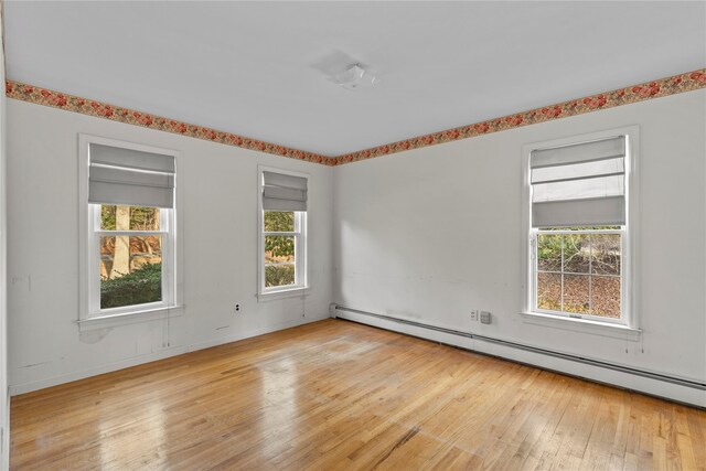 46 Mount Grey Rd, Setauket, NY 11733 - spare room featuring a baseboard heating unit and hardwood / wood-style flooring