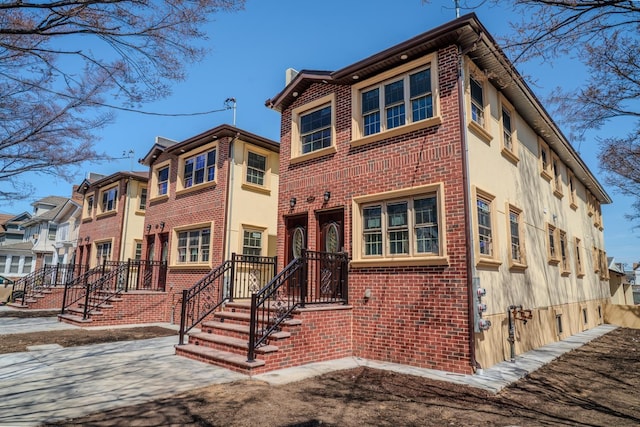 view of front of property with brick siding and stucco siding
