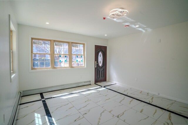 foyer entrance featuring recessed lighting, marble finish floor, and a baseboard heating unit
