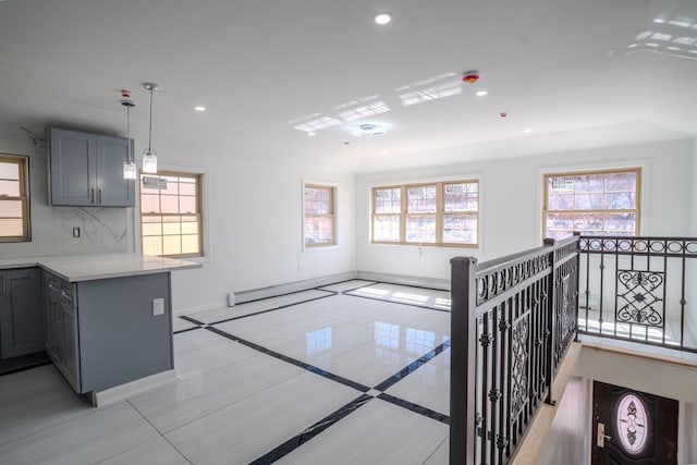 hallway with baseboards, plenty of natural light, and recessed lighting