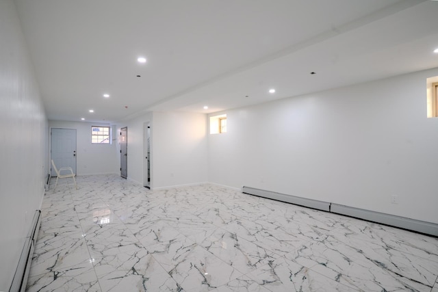 below grade area featuring a baseboard radiator, plenty of natural light, and recessed lighting